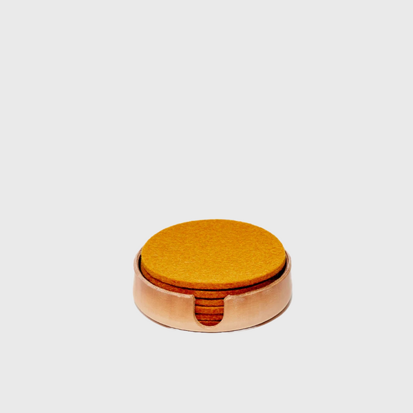 Vegetable tanned round leather tray to hold felt coasters by graf lantz