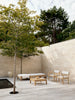Lifestyle image of AH604 Outdoor Lounger, FSC™-certified teak, untreated, Designed by Alfred Homann for Carl Hansen & Søn
